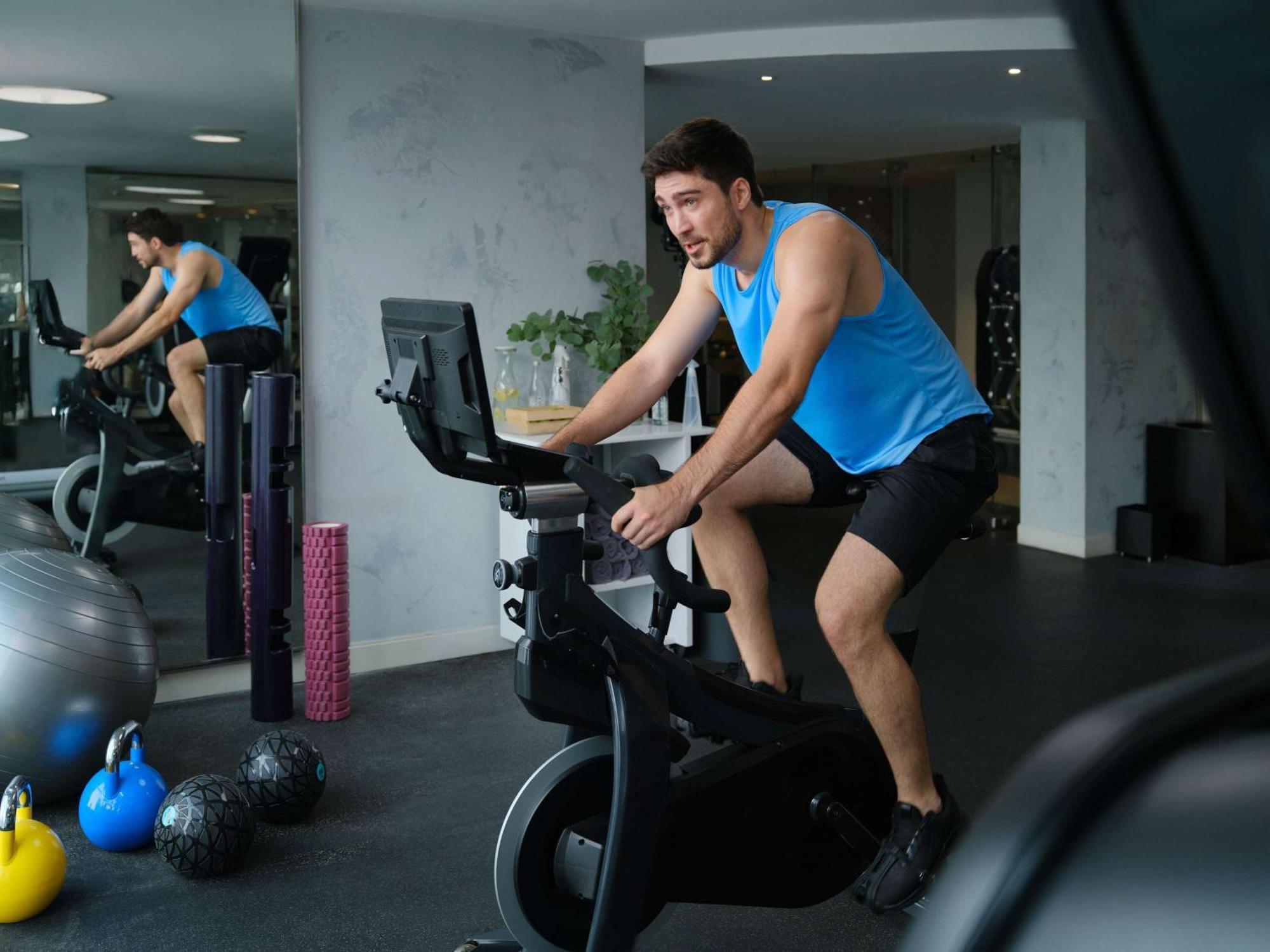 Pullman Jakarta Central Park Esterno foto A man on a stationary bicycle
